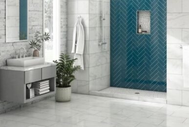 "Modern bathroom with marble tiles, a blue herringbone shower wall, a floating vanity, plants, and a large window.