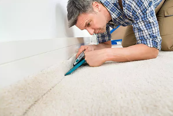 Carpet fitter in Bradford trimming and fitting carpet – How Much Does Carpet Fitting Cost?