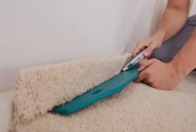 Professional carpet fitter securing carpet edges in Bradford – Cost of Carpet Fitting.