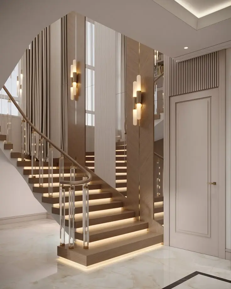 A sleek modern staircase featuring a stylish light fixture and a mirror, showcasing luxurious design elements.